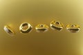 3d render of golden glazed flying donuts on a gold metallic background