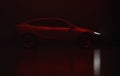 3D Render of a gray colored modern electric car, full right side view under red light, black background Royalty Free Stock Photo