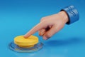 3D Render of a Hand Pressing a Yellow Button on a Blue Background Royalty Free Stock Photo