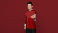 3D Render :Handsome Asian smiling man with Chinese traditional dress male cheongsam or qipao holding ang pow