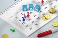 16th calendar with pins and gold coins and blue cubes with word TAX. Royalty Free Stock Photo