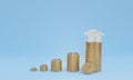 3D render image of coin stacks with house, concept of saving or investment for property