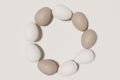 3d render of ivory and brown easter eggs on a beige background