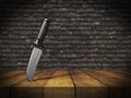 3D knife stuck in wooden table against grunge brick wall