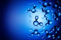 Models of H2O water molecules in front of blue background. Copy space Royalty Free Stock Photo
