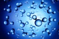 Models of H2O water molecules in front of blue background Royalty Free Stock Photo