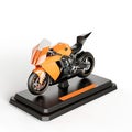 3D render of a modern orange motorcycle parked on a black stand against a white background Royalty Free Stock Photo