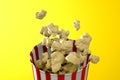 3d render of monochrome yellow popcorn box. Levitation food. Cinema snack concept