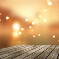 3D old wooden table looking out to a golden bokeh lights defocussed background Royalty Free Stock Photo