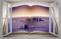 3D render of an opened photo book with a small rocky island in the middle of the northern Ireland sea seen from a window - toned