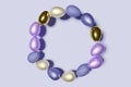 3d render of pastel colored Easter eggs frame wreath on a violet color of the year 2022 background Royalty Free Stock Photo