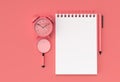3D Render Pen and Notepad with Alram Clock on the Pastel Coral Background Royalty Free Stock Photo