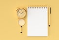 3D Render Pen and Notepad with Alram Clock on the Pastel Yellow Background Royalty Free Stock Photo