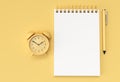 3D Render Pen and Notepad with Alram Clock on the Pastel Yellow Background Royalty Free Stock Photo