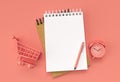 3D Render Pen and Notepad with Alram Clock and Shopping Cart on the Pastel Color Background Royalty Free Stock Photo