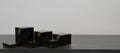 3D render podium made of black marble with gold texture cube on white background