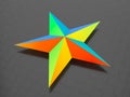3D render - rainbow colored star on carbon fiber background