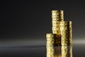 Rising stacks of Euro coins with a seamless dark background and reflections