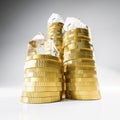 Rising stacks of Euro coins topped with model houses made from acrylic glass. Seamless white background and reflections Royalty Free Stock Photo