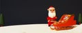 3D Render Santa Claus Standing Near Sleigh Full Of Gift Boxes And Xmas Tree Against Snowy Black Background With Copy