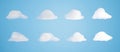 3D render of set isolated white cartoon clouds on blue background. Royalty Free Stock Photo