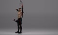 3D Render : a shirtless young male archer pose practicing archery in the studio