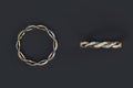 3D Side view and top view of twisted rings with diamonds surrounding the ring on black background. Royalty Free Stock Photo