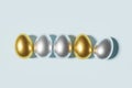 3d render of silver and gold easter eggs on a sky blue background Royalty Free Stock Photo