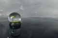 3d render of snowglobe with palm tree on open waters with cloudy sky Royalty Free Stock Photo