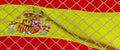 Spanish flag behind steel mesh wire fence. the flag of spain