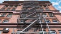 3D render of a staircase leading upward adjacent to the red brick building .