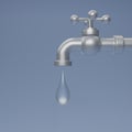 3D render Steel water tap with falling drop. Water tap icon Isolated on blue background. Save water advertising ecology concept.