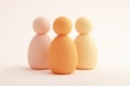 3D render of three simple human figures in different shades of pastel peach and cream, on a white background Ai photo Royalty Free Stock Photo