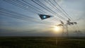 3d render. UFO over the field and high-voltage power lines Royalty Free Stock Photo