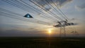 3d render. UFO over the field and high-voltage power lines Royalty Free Stock Photo