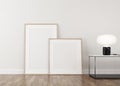 3d Render of white frames in light plaster wall and wood floor