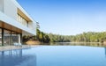 3D render of white modern house with swimming pool on lake background, Exterior with large window design