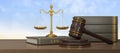 3D render wooden judge gavel and golden balance scale on wood table with blue sky background. Judge hammer icon law gavel.