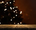 3D wooden table looking out to a defocussed Christmas tree Royalty Free Stock Photo