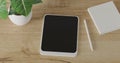 3d render Working desk with white background. tablet, pencil, green plant and coffee cup on wood table. minimal workspace. wall