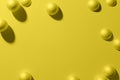 3d render yellow matte metallic spheres frame on a monochrome background