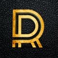 3D rendered golden letter R against a black leather surface