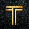 3D rendered golden letter T against a black leather background