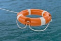3D rendered illustration of orange life buoy. Ocean in background