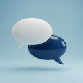 Two overlapping 3D speech bubbles, one white and one dark blue, on a light blue background Royalty Free Stock Photo