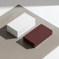 A 3d rendered image of a white cube and a red rectangular prism on a gray surface Royalty Free Stock Photo
