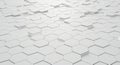 A 3D-rendered pattern of white hexagonal tiles creating a textured surface. Some tiles Royalty Free Stock Photo
