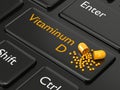 3d rendered vitamin D pill lying on keyboard