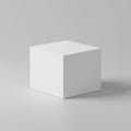 A 3D-rendered white cube sits on a smooth gray surface. The cube is evenly lit, casting Royalty Free Stock Photo