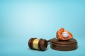 3d rendering of baseball and baseball glove lying on sounding block with judge gavel beside on light-blue background.